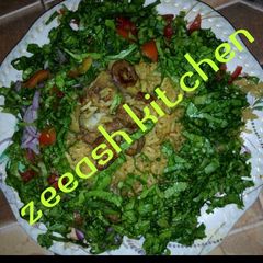 A picture of Jallof rice with lettuce.