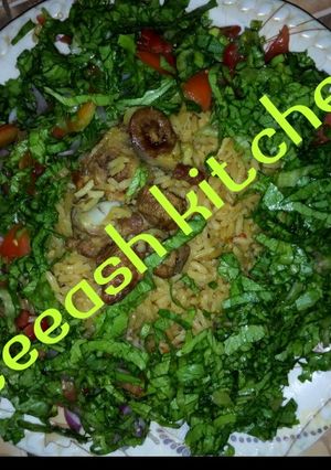 A picture of Jallof rice with lettuce.