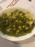 Papas con poblano, granitos de elote y nopales en chile verde