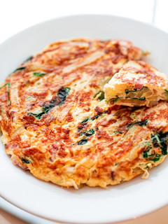 A picture of Spanish omelet with spinach and cheese.