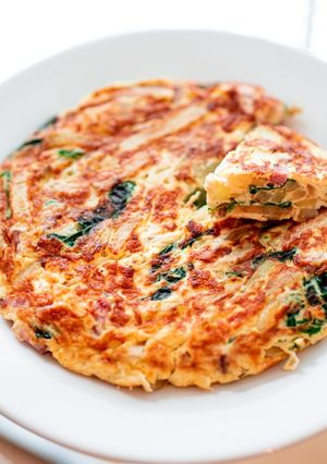 A picture of Spanish omelet with spinach and cheese.
