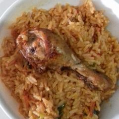 A picture of Jollof Rice with chicken.