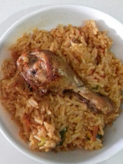A picture of Jollof Rice with chicken.