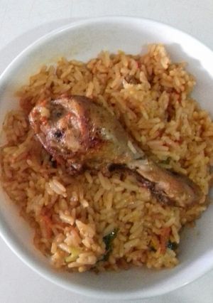 A picture of Jollof Rice with chicken.