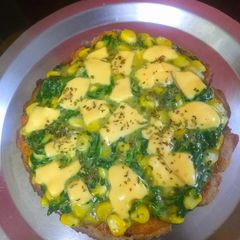 A picture of Multi grain base spinach corn topped pizza.