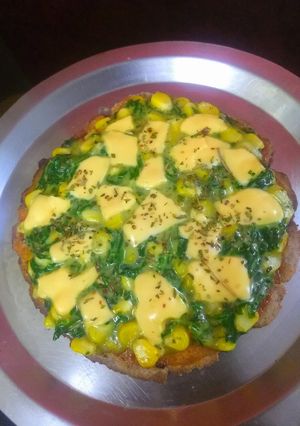 A picture of Multi grain base spinach corn topped pizza.