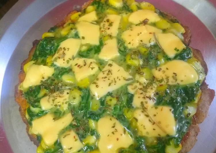 Multi grain base spinach corn topped pizza