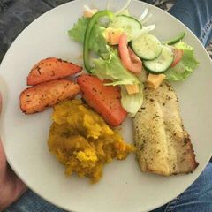 A picture of Grilled hake fillet with veggies.