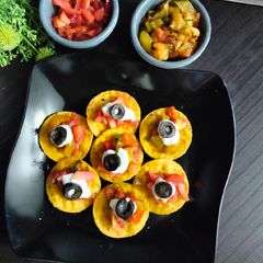 A picture of Jain Nachos with Salsa and cream cheese.