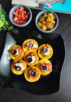A picture of Jain Nachos with Salsa and cream cheese.