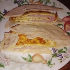 A picture of Ham and cheese 🧀 omlet in pita bread 🍞🍞🍞.