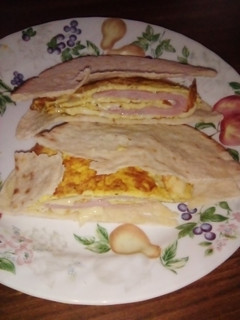A picture of Ham and cheese 🧀 omlet in pita bread 🍞🍞🍞.
