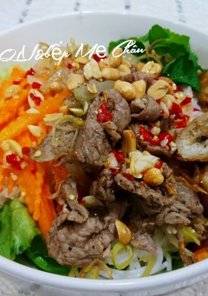 A picture of Lemongrass Beef Noodle Salad with Egg Rolls.