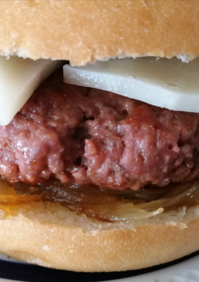 Una foto de Hamburguesa casera Tex-mex con cebolla caramelizada y queso