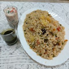 A picture of Veg polaw with onion raita.