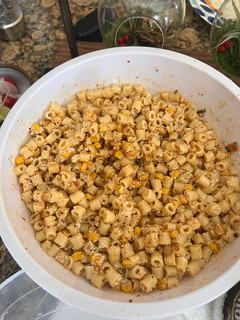 A picture of Macaroni salad with roasted corn.