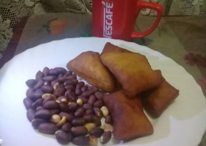 Roasted nuts, cardamom mandazi n a cup of hot black Nescafe