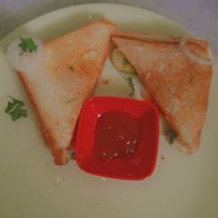A picture of 3 layered cheese sandwich.