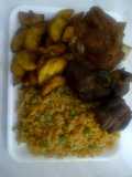 Jolly rice with fried goat meat and plantain
