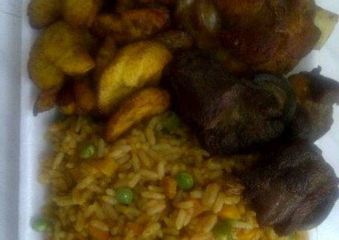 Jolly rice with fried goat meat and plantain