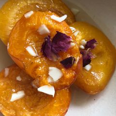 A picture of Baked apricots with rose water and cardamom.