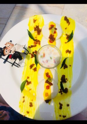 A picture of Kesari Rasmalai topping with crunchy nuts.