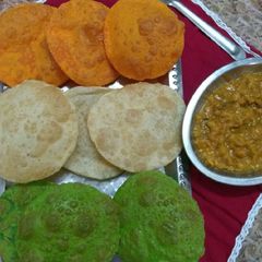 A picture of Tri colour Poori with white matar.