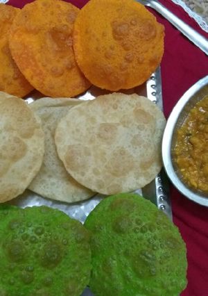 A picture of Tri colour Poori with white matar.