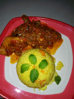 A picture of Yellow rice with sauce.