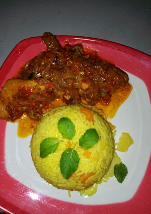 A picture of Yellow rice with sauce.