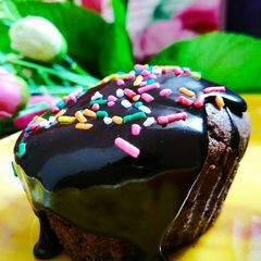 A picture of Egg less chocolate cup cakes with chocolate ganache topping.