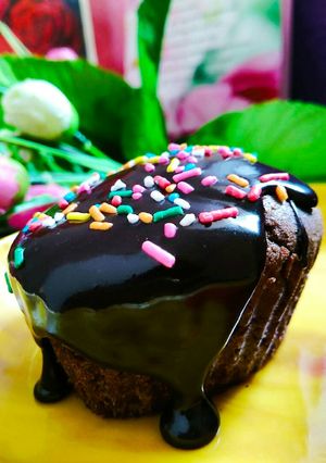 A picture of Egg less chocolate cup cakes with chocolate ganache topping.