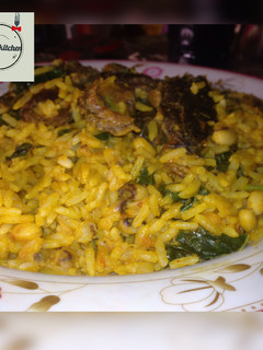 A picture of Palm oil rice and beans jallof with spinach.