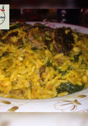 A picture of Palm oil rice and beans jallof with spinach.