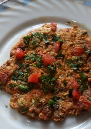 A picture of Egg tomato onion omlette.