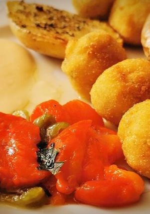 A picture of Cod Croquettes with Roasted Peppers and Potatoes.