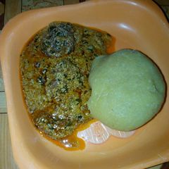 A picture of Eba and egussi soup with meat.