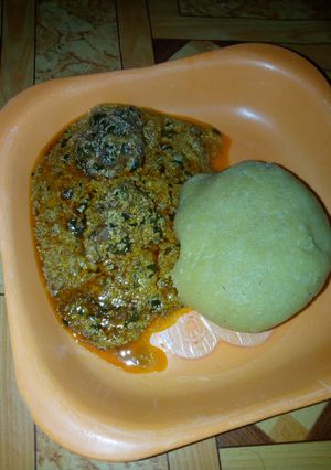 A picture of Eba and egussi soup with meat.