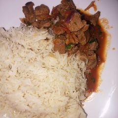 A picture of Rice served with mbuzi.