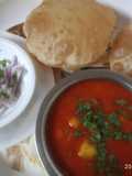 Aloo-tamatar ki khatti sabji with puri and onion salad