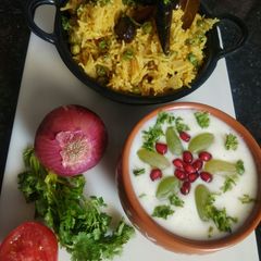A picture of Veg Pulav with Fruit Raita.