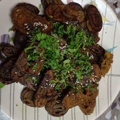 A picture of Homemade crispy Patra with some spicy green chutney.