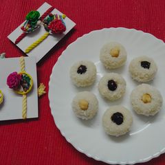 A picture of Chocolate coated Hazelnut filled coconut laddu.