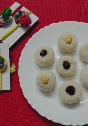 A picture of Chocolate coated Hazelnut filled coconut laddu.
