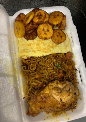 A picture of Stir fry Noodles,omelette egg,plantain and chicken.