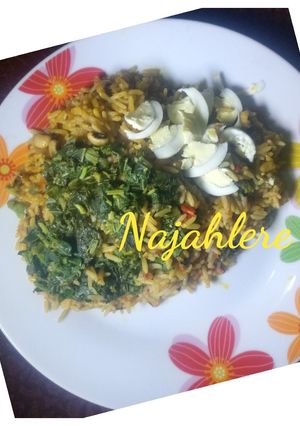 A picture of Palm oil rice and beans with spinach.