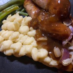 A picture of Staffordshire Pork & Leek Sausages with Mustard Mash and the best Red Wine & Onion Gravy.