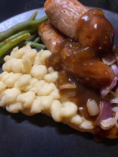 A picture of Staffordshire Pork & Leek Sausages with Mustard Mash and the best Red Wine & Onion Gravy.