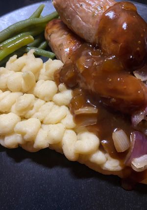 A picture of Staffordshire Pork & Leek Sausages with Mustard Mash and the best Red Wine & Onion Gravy.