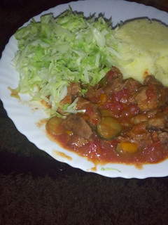 A picture of Mashed potatoes, beef stew n steamed cabbages.
